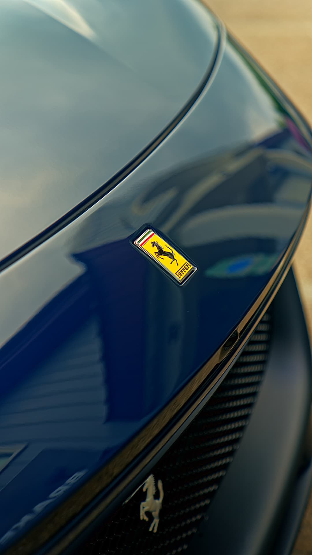 Close-up of a Ferrari badge and hood line after detailing by Brakeout Auto